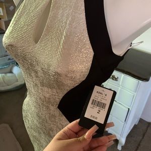 This is a black and off white midi dress with no sleeve from the brand Jax.